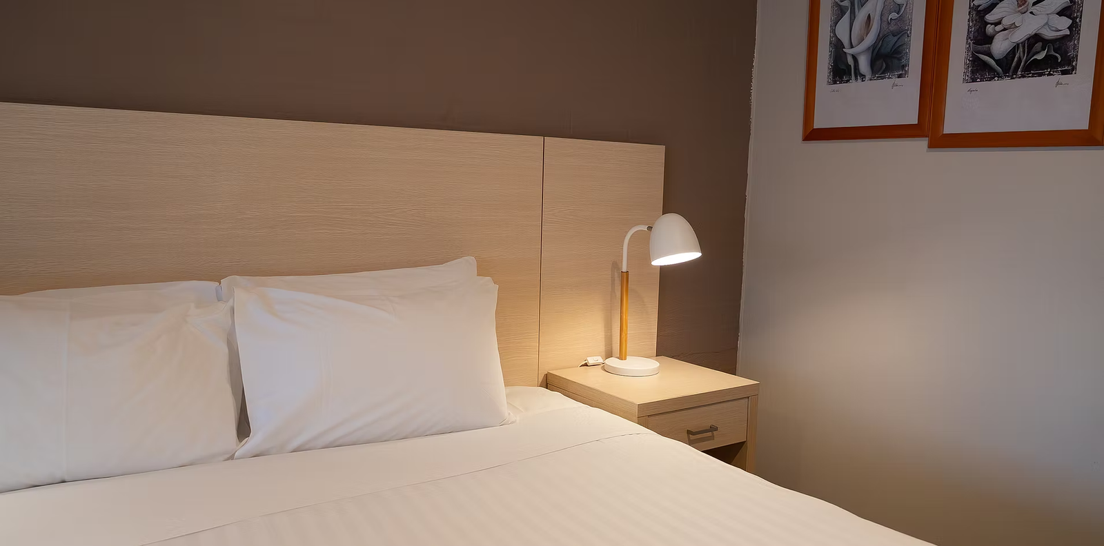Guest room bedside detail with reading lamp